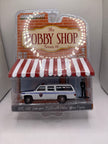 Greenlight 1985 GMC Suburban 2500 With Police Officer Figure Diecast